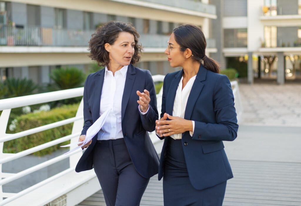 two women wearing navy blue suit