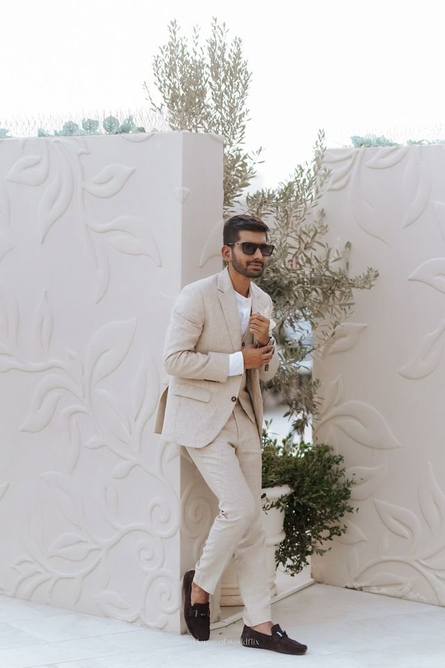 A man dressed in a beige color suit