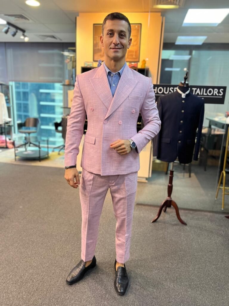 A man dressed beautifully in a light pink suit