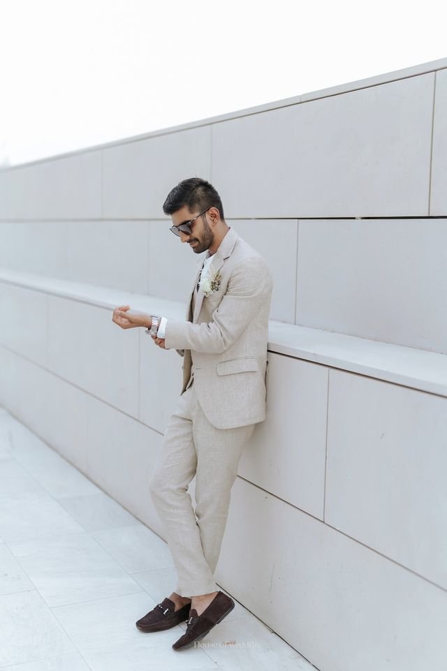 A man dressed in a beige color suit