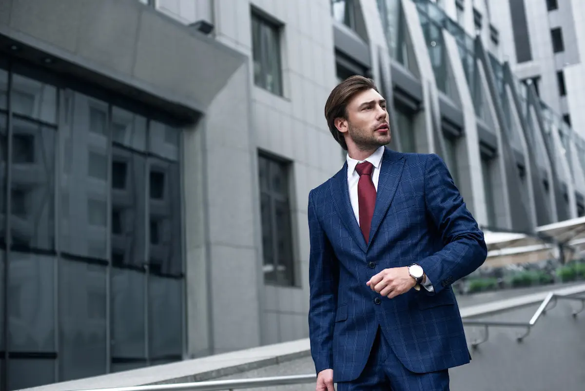 Modern power dressing in Britain with a professional wearing a bespoke suit in a London business district