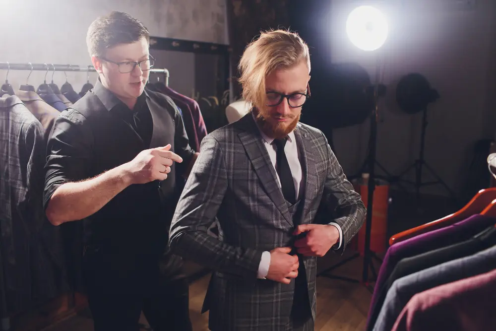 Bespoke suit fitting assessing jacket balance and shoulder alignment