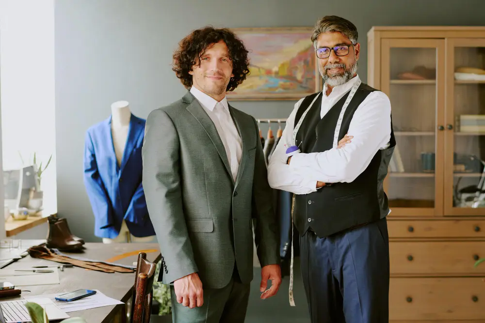 Client reviewing the fit of a bespoke suit with an independent tailor in London