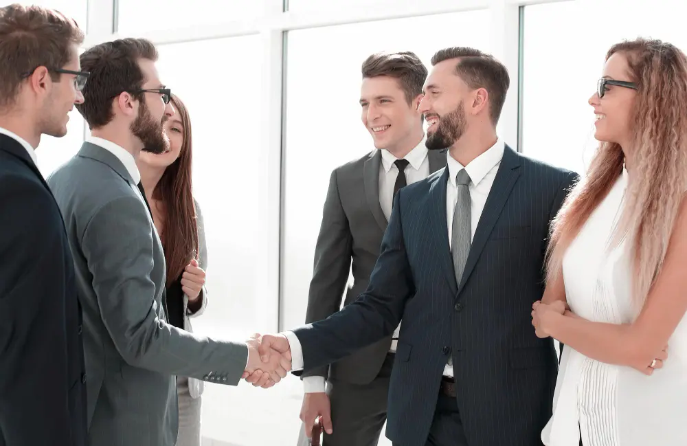 Business professionals networking at a FIFA World Cup hospitality event while wearing tailored business attire